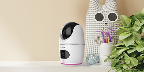 Lorex 2K Dual Lens Indoor Pan-Tilt Camera on a shelf in a child's room, a smart and user-friendly solution for everyday family monitoring and emergencies.