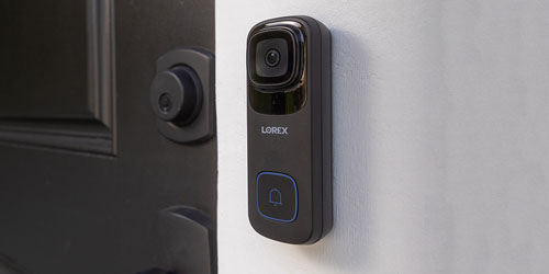 Black 4K Wired Smart Video Doorbell beside black door